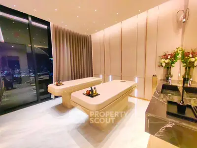 Luxurious spa room with city view, featuring elegant massage tables and ambient lighting.