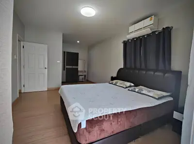 Spacious bedroom with modern furnishings and ample natural light