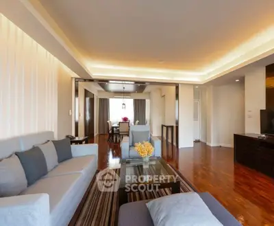 Spacious living room with modern furniture and elegant lighting