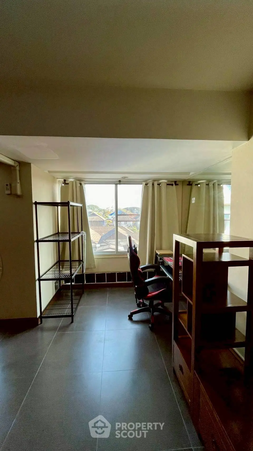 Spacious study room with large window and modern furniture