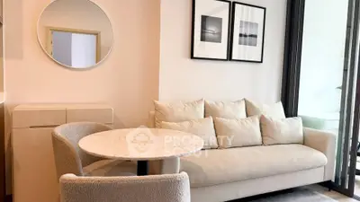 Modern living room with cozy sofa, round table, and stylish decor in a bright apartment.
