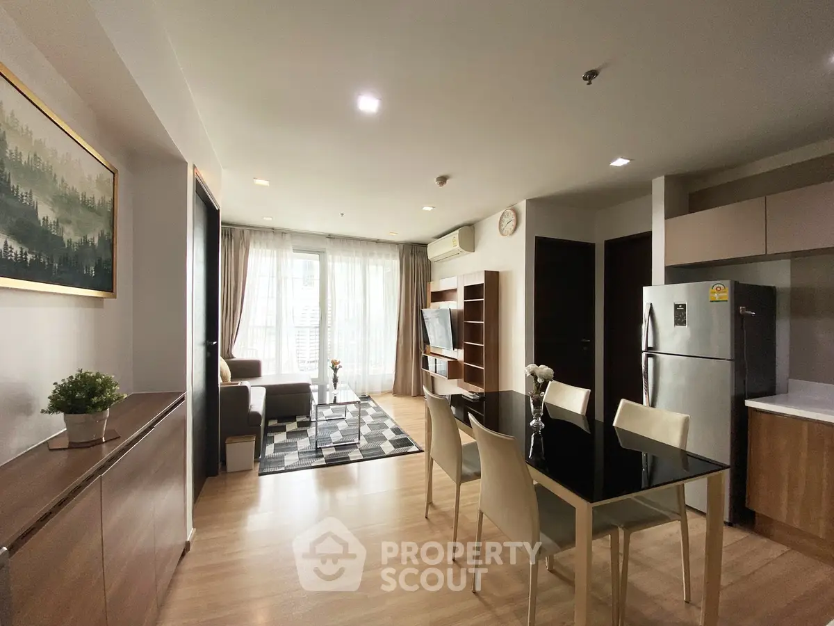 Modern open-plan living and dining area with stylish decor and natural light.