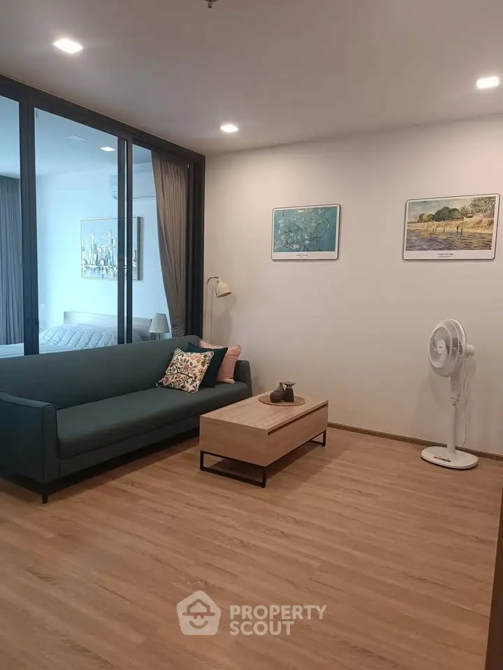 Modern living room with sleek design and cozy ambiance, featuring a stylish sofa and elegant decor.