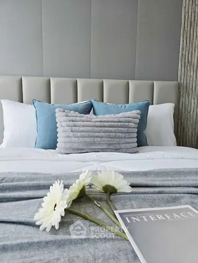 Elegant bedroom with plush pillows and modern decor, perfect for relaxation and comfort.