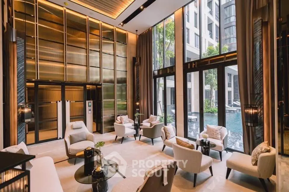 Luxurious modern lobby with elegant seating and pool view in upscale residential building.