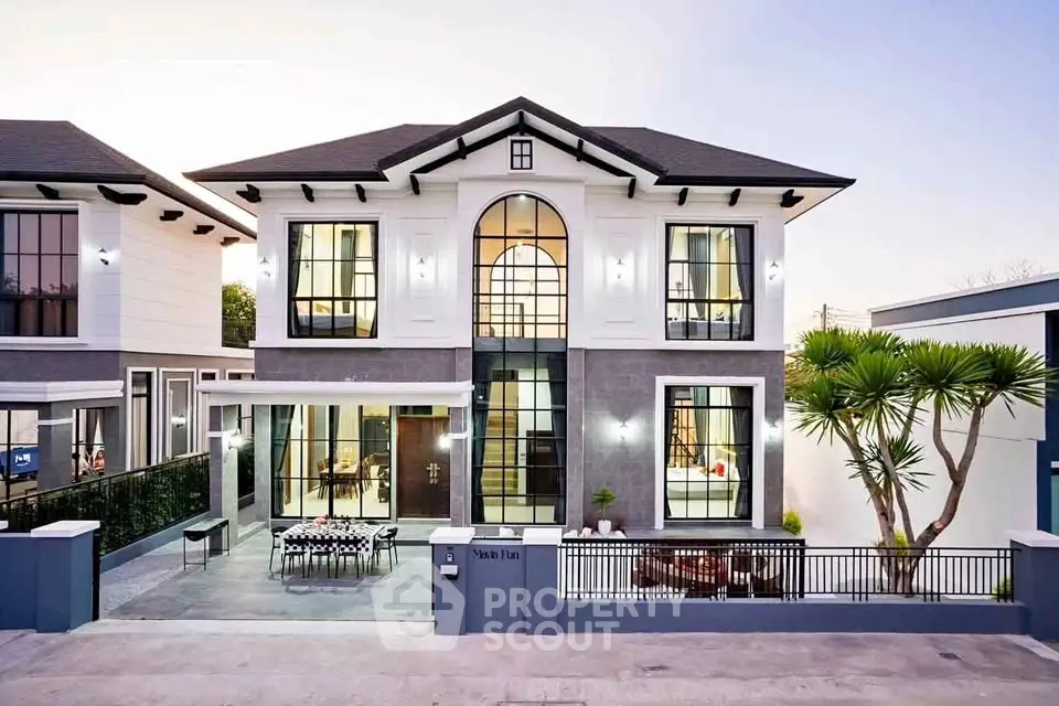 Stunning modern two-story house with large windows and elegant facade
