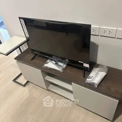 Modern living room setup with sleek TV stand and flat-screen TV
