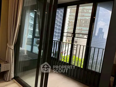 Modern apartment balcony with city view and glass doors