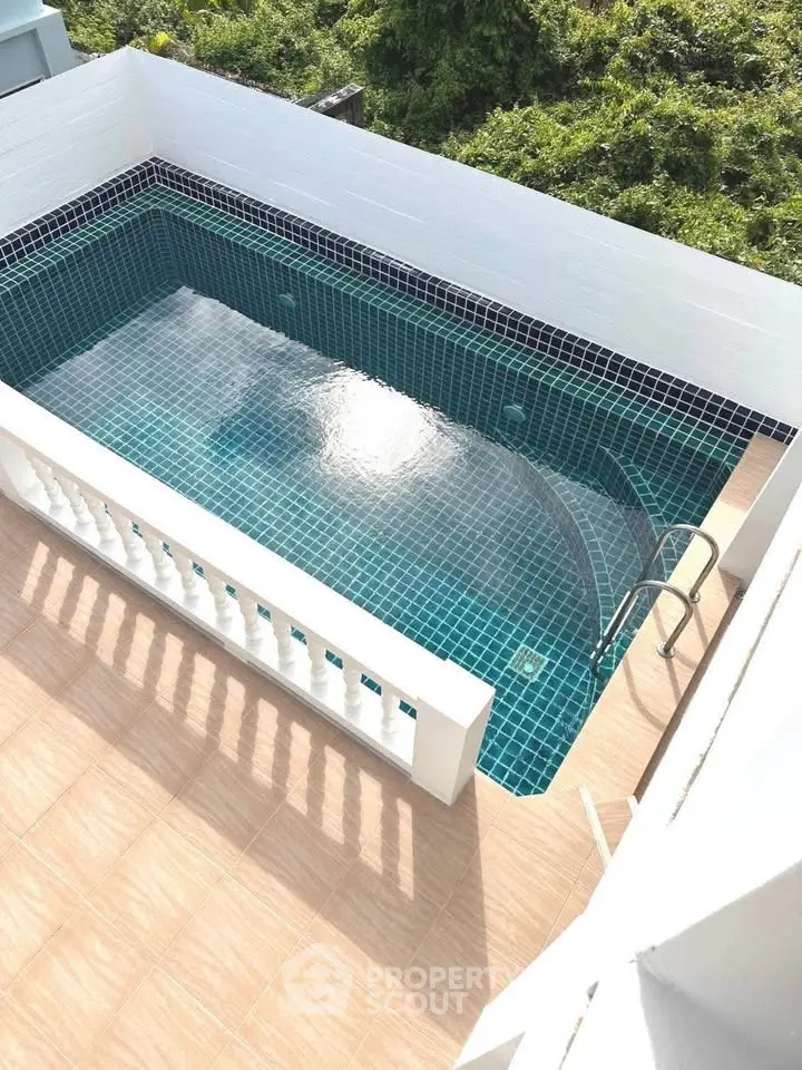 Charming rooftop pool with elegant tile design and serene surroundings.
