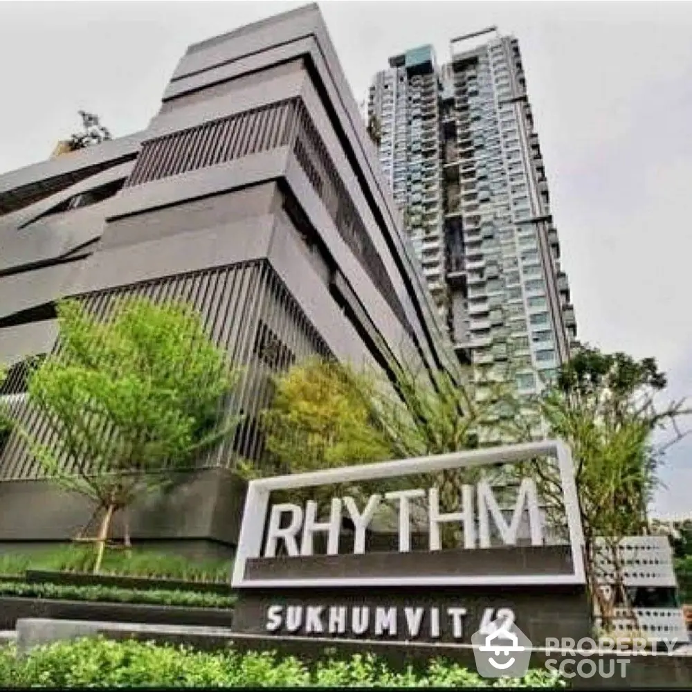 Modern high-rise condominium Rhythm Sukhumvit 42 with lush greenery and sleek architecture.