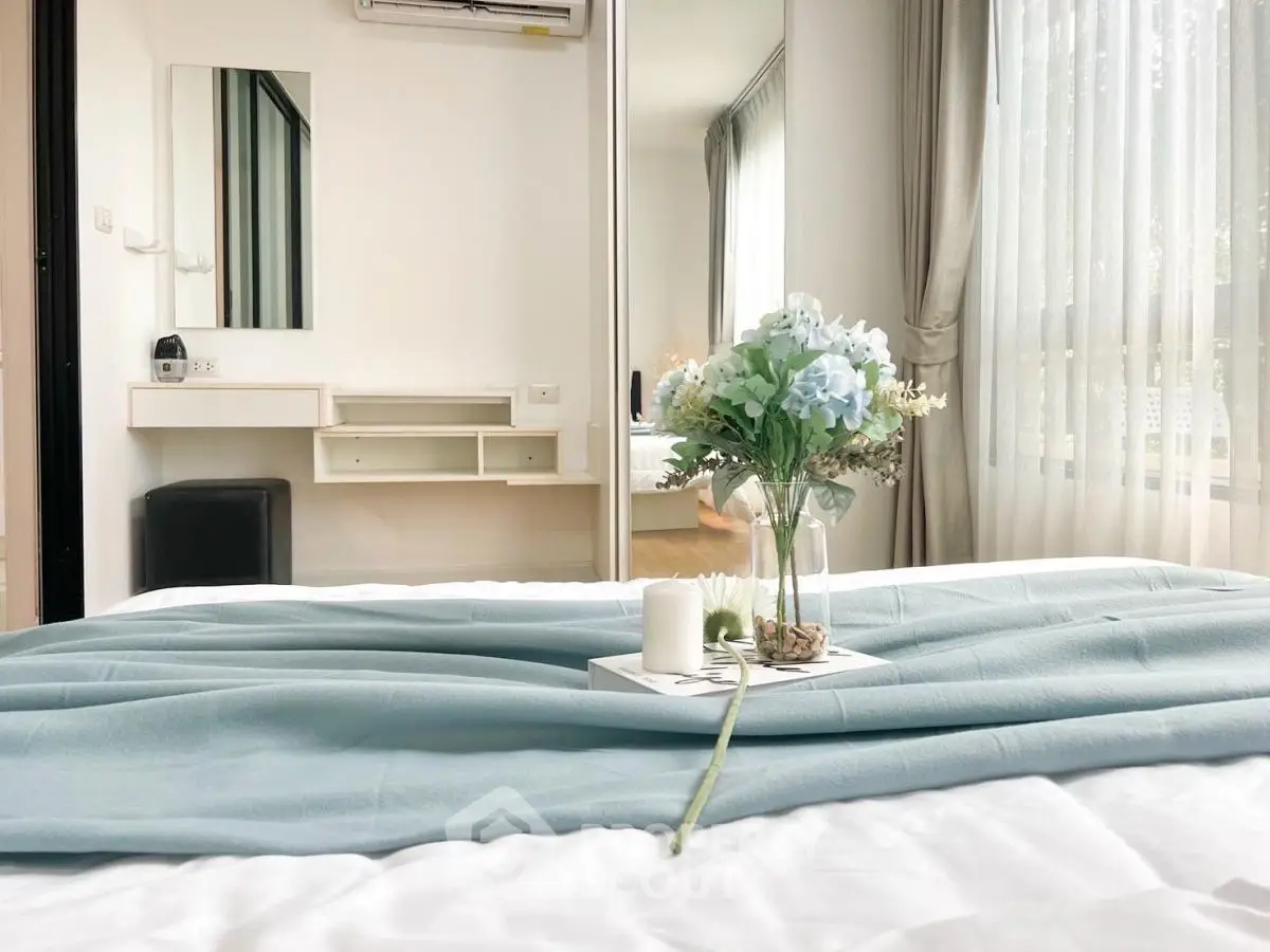 Elegant bedroom with soft lighting and stylish decor, featuring a cozy bed and large windows.