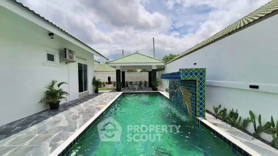 Luxurious private pool with modern design and lush greenery in a serene residential setting.