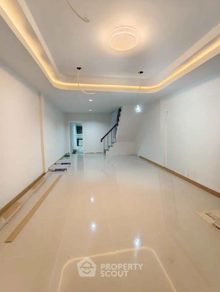 Spacious modern living room with elegant ceiling lights and glossy tiled floor