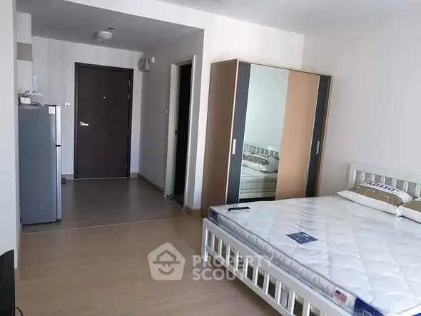 Spacious bedroom with modern furniture and ample storage in a stylish apartment.