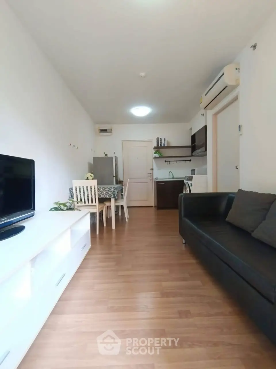 Modern living room with sleek furniture and open kitchen layout