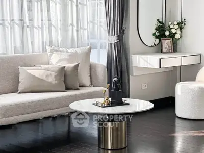 Elegant living room with modern decor, featuring a sleek coffee table and plush sofa in a sunlit space.