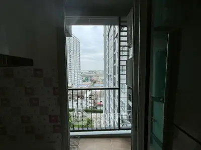 High-rise apartment balcony with city view, showcasing modern urban living and panoramic skyline.