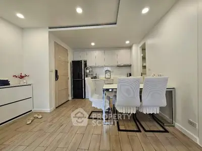 Modern kitchen with dining area and sleek wooden flooring