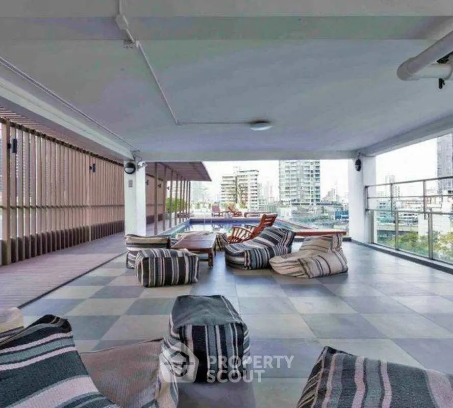Spacious rooftop terrace with modern seating and city views, perfect for relaxation and entertainment.