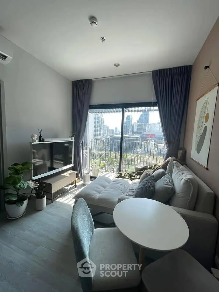 Modern living room with city view, stylish furniture, and natural light