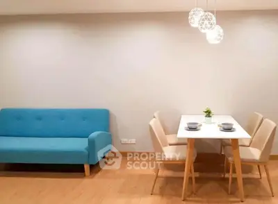 Modern living room with blue sofa and elegant dining area