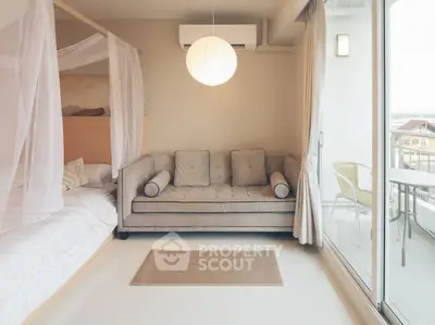 Modern bedroom with cozy sofa and balcony access in stylish apartment