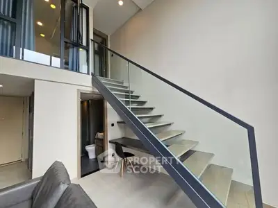 Modern duplex apartment with sleek staircase and open layout