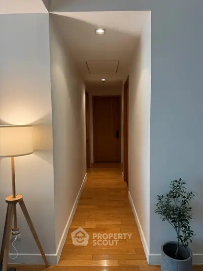 Elegant hallway with wooden flooring and modern decor in a stylish home.