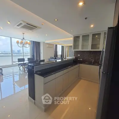 Spacious modern kitchen with open layout and dining area, featuring elegant lighting and city view.