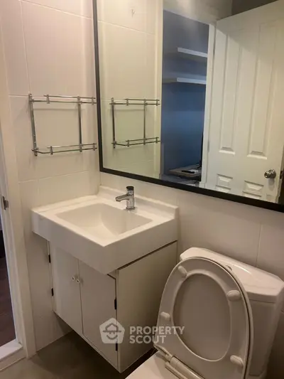 Modern bathroom with sleek sink and mirror in a stylish apartment.