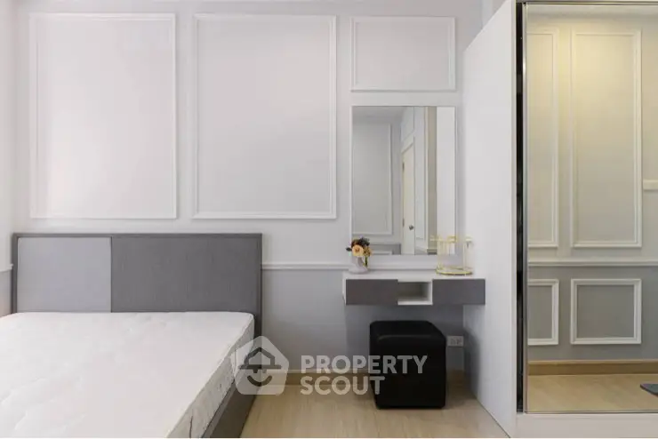 Modern bedroom with sleek design and mirrored wardrobe