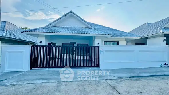 Charming single-story home with modern design and spacious driveway in a serene neighborhood.