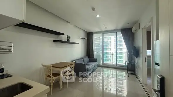 Modern living room with sleek design and balcony view in urban apartment.