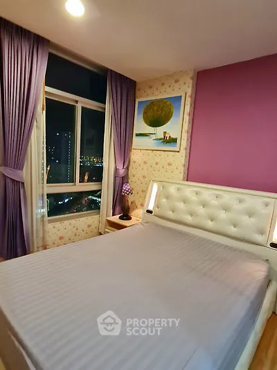 Cozy bedroom with city view, purple curtains, and stylish decor