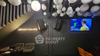 Chic modern lounge with ambient lighting and wall-mounted TV in Bangpo Square.
