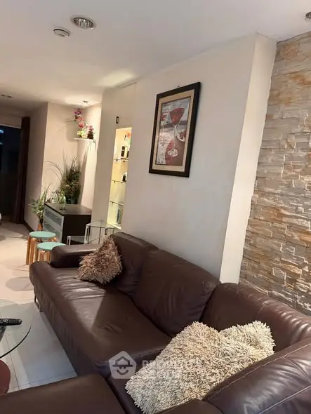 Cozy living room with brown leather sofa and stylish decor