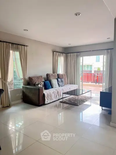 Spacious living room with modern decor and large windows for natural light.