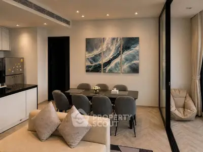 Modern open-plan living and dining area with stylish decor and natural lighting.