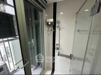 Modern bathroom with glass shower and city view from window