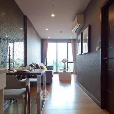 Modern living room with elegant decor and large windows offering natural light.