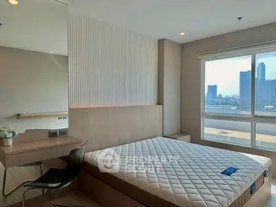 Modern bedroom with city view, featuring sleek furniture and large window for natural light.