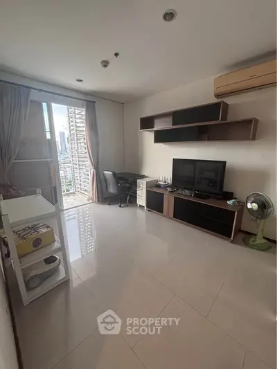 Modern living room with city view, sleek furniture, and natural light in a high-rise apartment.