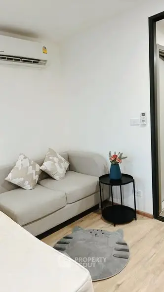 Cozy living room with modern sofa and air conditioning unit