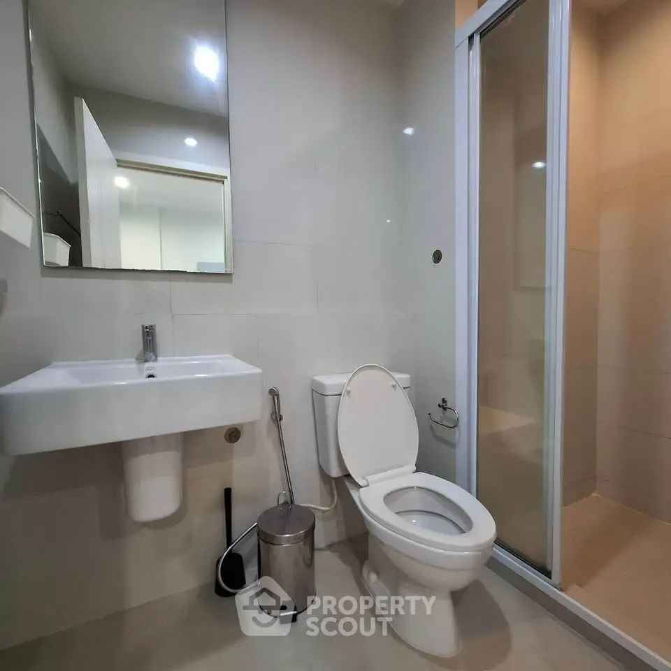 Modern bathroom with sleek fixtures and a glass shower enclosure