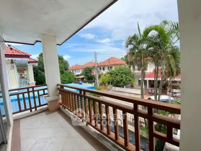 Charming balcony with scenic neighborhood view and lush greenery.