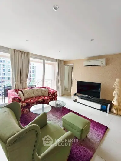 Spacious living room with modern decor and balcony view in luxury apartment.