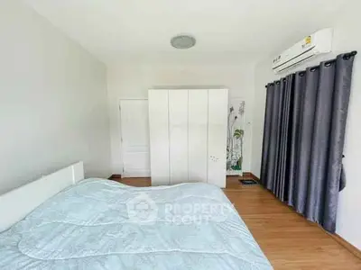 Spacious bedroom with modern air conditioning and ample storage space.