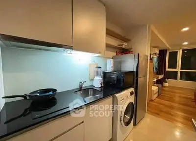 Modern kitchen with sleek appliances and open layout in stylish apartment