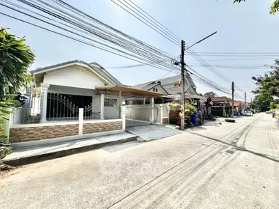 Charming suburban house with gated entrance and driveway in a peaceful neighborhood.