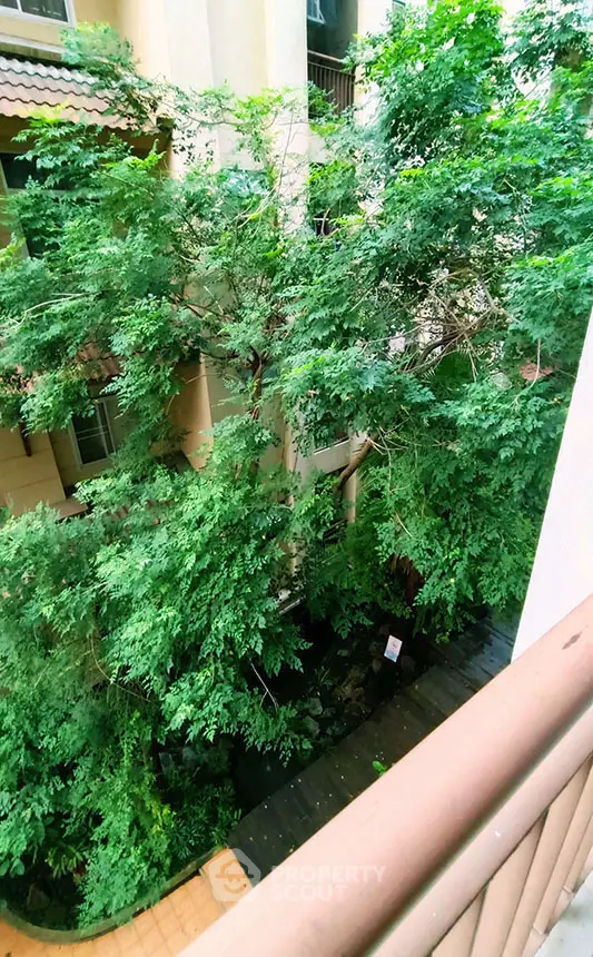 Lush green garden view from a balcony in a residential building